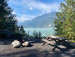 A sit with a fire pit and view of the water at Klahanie Campground - thumbnail